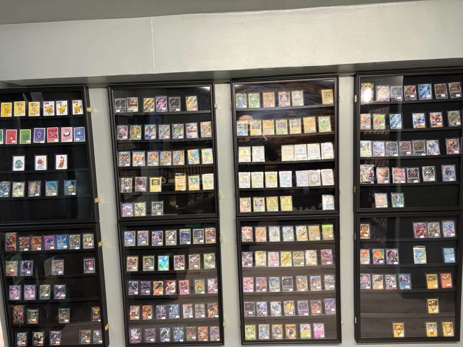 Display cases packed with hundreds of Pokémon cards