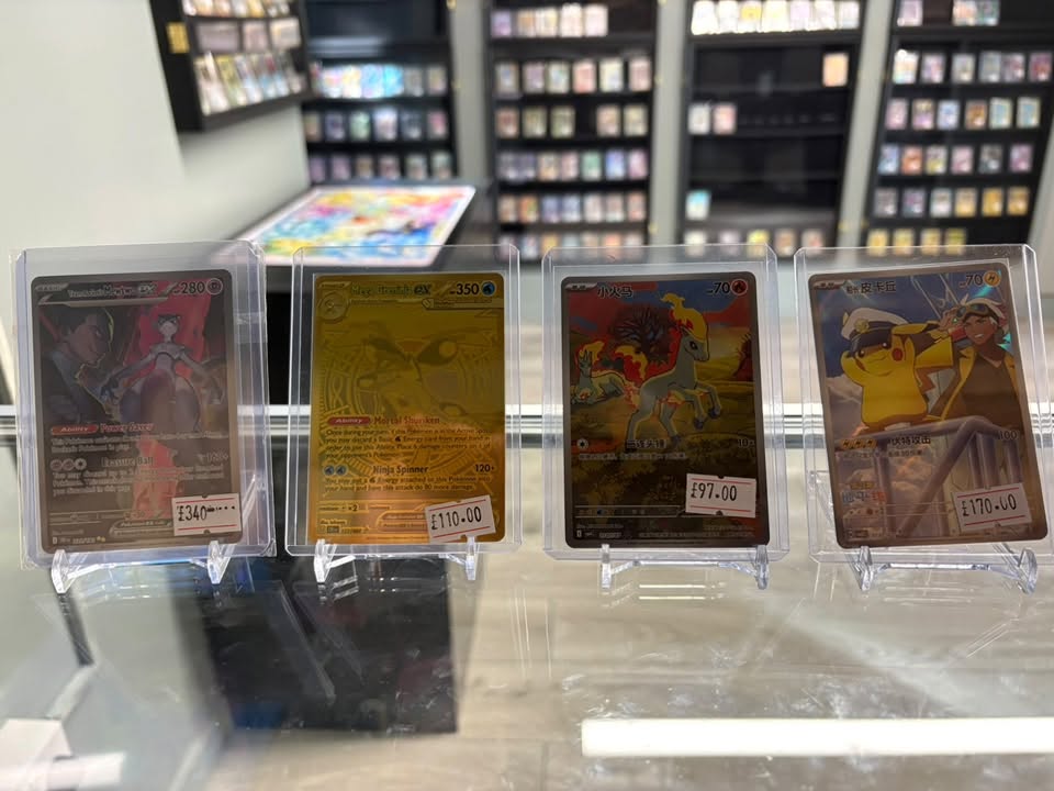 Graded Pokémon cards on display with prices